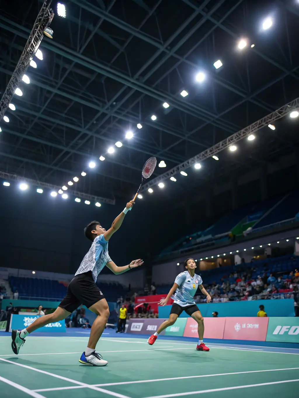 Advanced badminton players engaged in a competitive match during a training session at the ROANNE BADMINTON CLUB (CBR42).